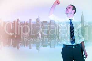 Composite image of businessman cheering with clenched fist