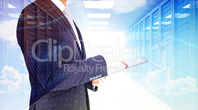 Composite image of businessman using his tablet pc