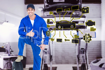 Composite image of mechanic with tire and wheel wrenches gesturi