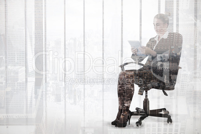 Composite image of businesswoman sitting on swivel chair with ta