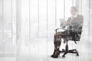 Composite image of businesswoman sitting on swivel chair with ta