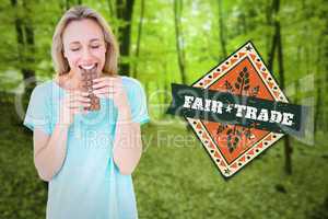 Composite image of happy blonde eating bar of chocolate