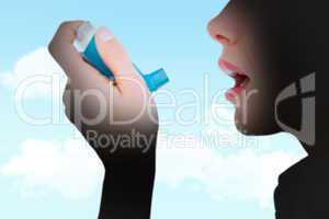 Composite image of close up of a woman using an asthma inhaler