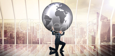 Composite image of businessman carrying the world