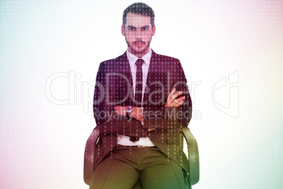 Composite image of serious businessman sitting with arms crossed