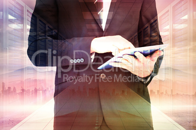 Composite image of businessman touching his tablet pc