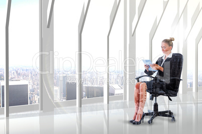 Composite image of businesswoman sitting on swivel chair with ta