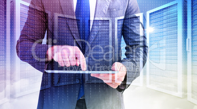 Composite image of businessman using his tablet pc