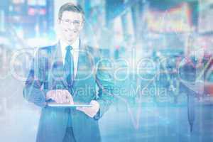 Composite image of businessman using his tablet pc