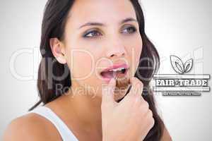 Composite image of pretty brunette eating chocolate candy