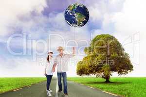 Composite image of smiling couple both wearing hats