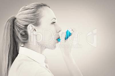 Composite image of pretty blonde using an asthma inhaler