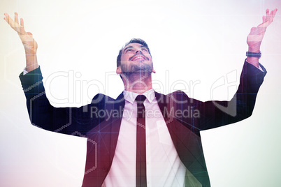 Composite image of businessman cheering with hands raised