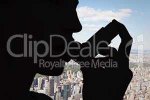 Composite image of blonde woman taking her inhaler
