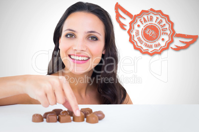 Composite image of pretty brunette picking out chocolate