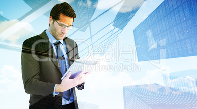 Composite image of businessman using a tablet computer