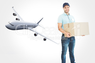 Composite image of courier man carrying cardboard box