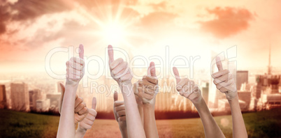 Composite image of thumbs raised and hands up