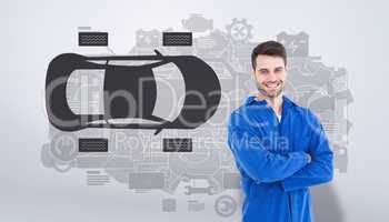 Composite image of smiling young male machanic standing arms cro