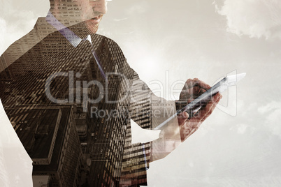 Composite image of mid section of a businessman using digital ta