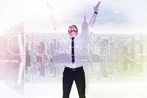 Composite image of smiling businessman cheering with his hands u