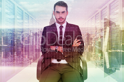 Composite image of serious businessman sitting with arms crossed