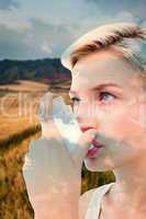 Composite image of blonde woman taking her inhaler