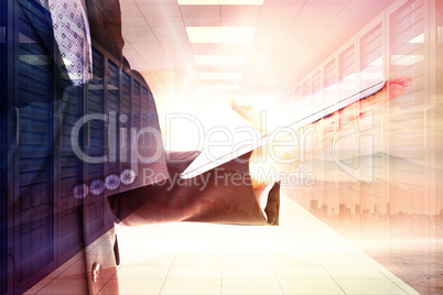 Composite image of businessman using his tablet pc