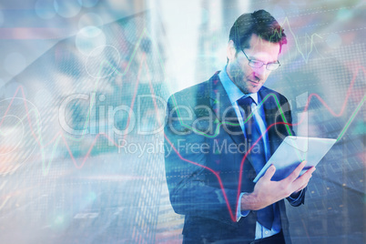 Composite image of businessman using a tablet computer