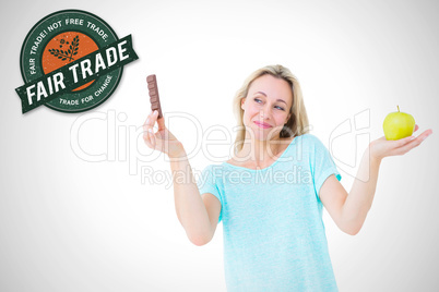 Composite image of smiling blonde holding bar of chocolate and a