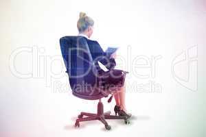 Composite image of businesswoman sitting on swivel chair with ta