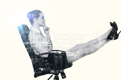 Composite image of businesswoman sitting on swivel chair with fe