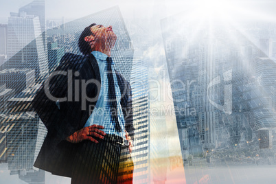 Composite image of cheerful businessman with hands on hips