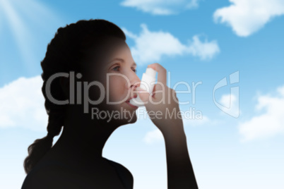 Composite image of woman using inhaler for asthma