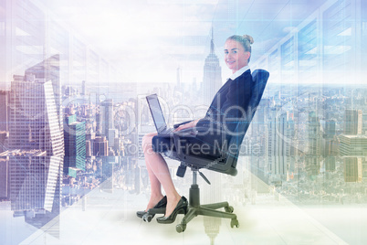 Composite image of businesswoman sitting on swivel chair with la