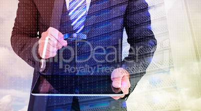 Composite image of businessman looking at tablet with magnifying