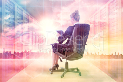 Composite image of businesswoman sitting on swivel chair with ta