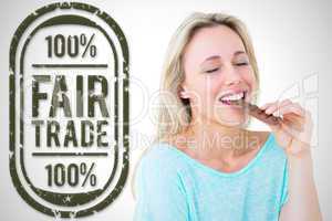 Composite image of pretty blonde enjoying and eating bar of choc