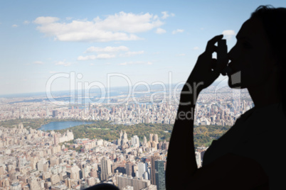 Composite image of asthmatic brunette using her inhaler