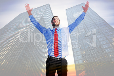 Composite image of happy cheering businessman raising his arms