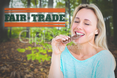 Composite image of pretty blonde enjoying and eating bar of choc