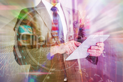 Composite image of businessman using his tablet pc