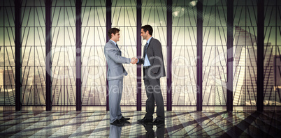 Composite image of businessmen shaking hands