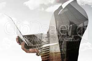 Composite image of businessman with watch using tablet pc