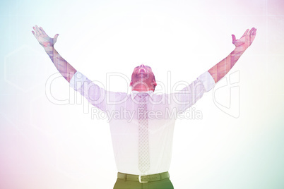 Composite image of handsome businessman cheering with arms up