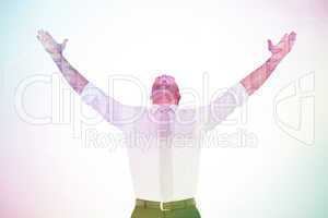 Composite image of handsome businessman cheering with arms up