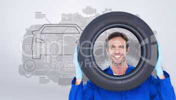 Composite image of confident mechanic looking through tire