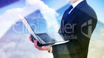 Composite image of businessman with watch using tablet pc