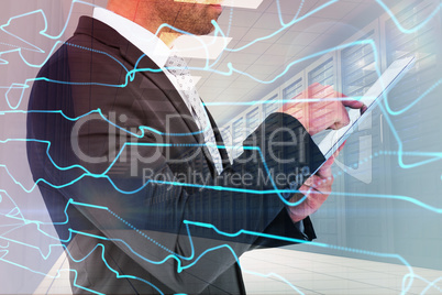 Composite image of businessman using his tablet pc Composite image of businessman using his tablet pc