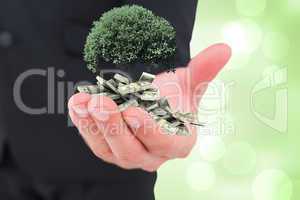 Composite image of businessman holding out his hand